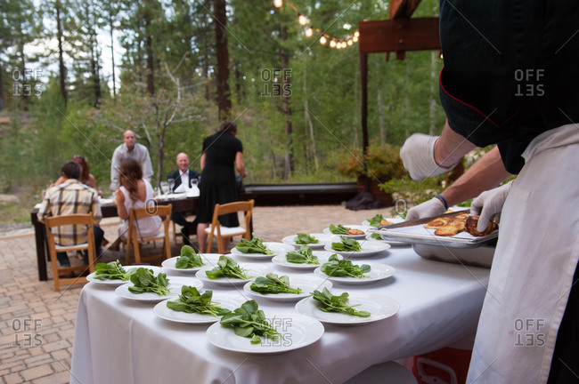 Chef plating a series of appetizers at an outdoor event in South Lake Tahoe, California, USA
