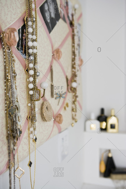 Detail jewelry hanging from french memo board