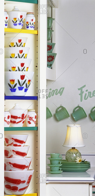 Patterened bowls and canisters in cupboard