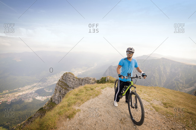 Cyclist at top of mountain, Carpathian Mountains