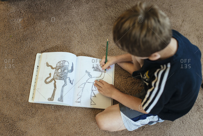 High angle view of a boy drawing on the floor