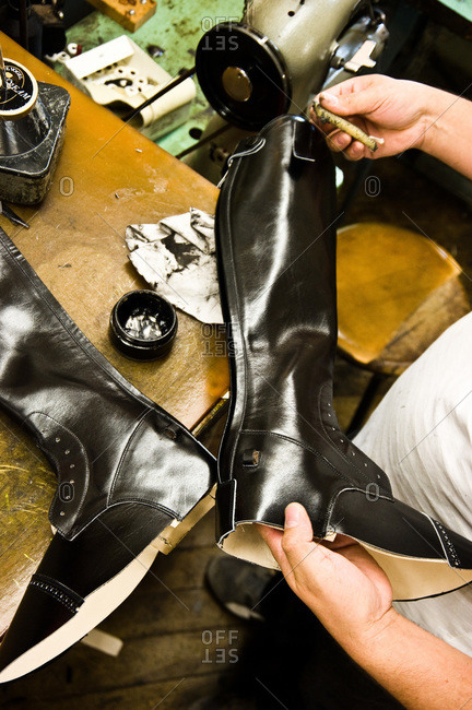 Shoemaker polishing leather boots
