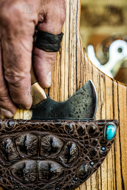 Leather craftsman holding a round knife