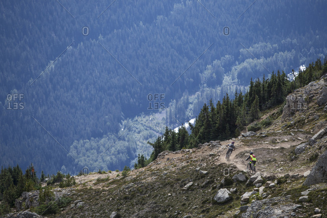 Bikers riding down a mountain path, Whistler, BC, Canada
