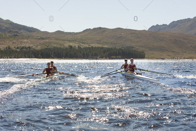 Two double scull rowing boats in water