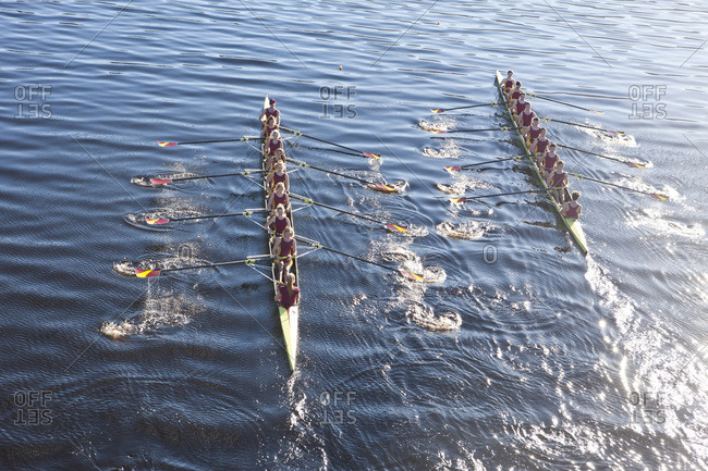 Overhead view of two rowing eights in water