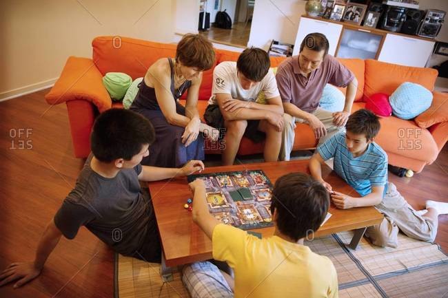Family playing board game at coffee table