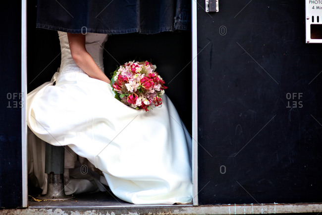 Bride with wedding bouquet in photo booth