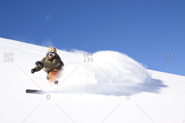 A male skier skiing at Big Sky Resort in Big Sky, Montana