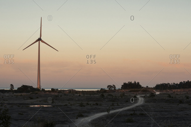 Silhouette of wind turbine at dusk