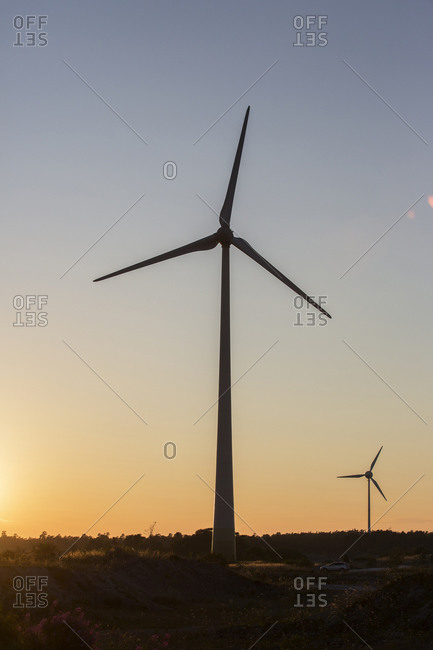 Silhouettes of wind turbines at dusk