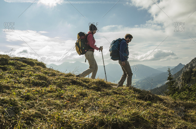 Young couple hiking on alpine meadow, Tyrol