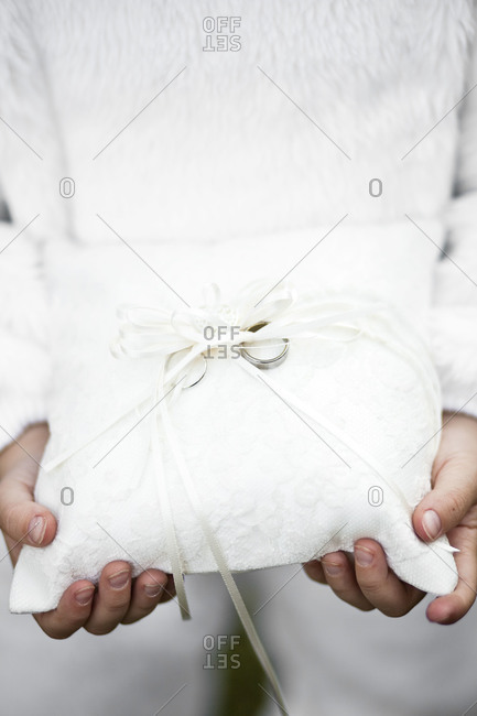 A boy holds wedding rings