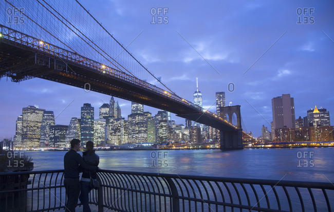 Two men looking at Manhattan skyline and Brooklyn Bridge