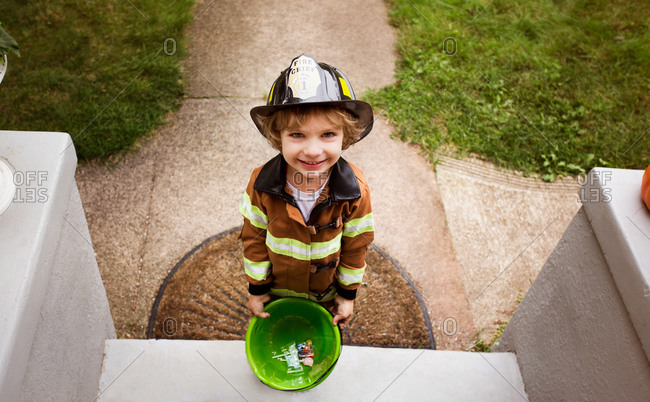 Kid in fireman costume on front step