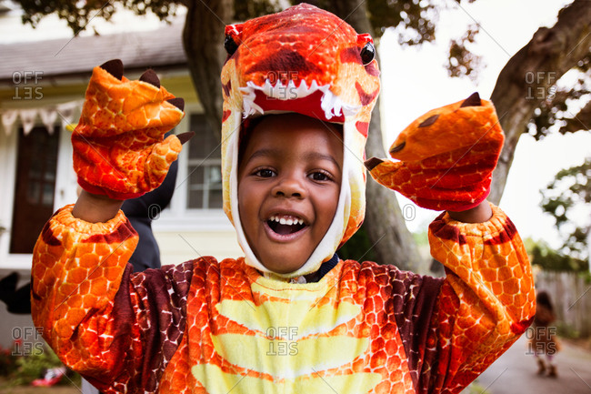 Boy in dinosaur costume being goofy