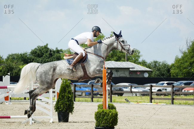 Man on horse jumping during competition