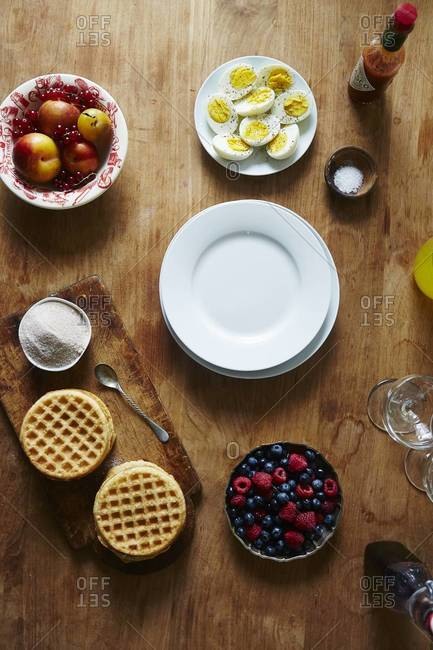Waffels with ripe fruits and halved eggs