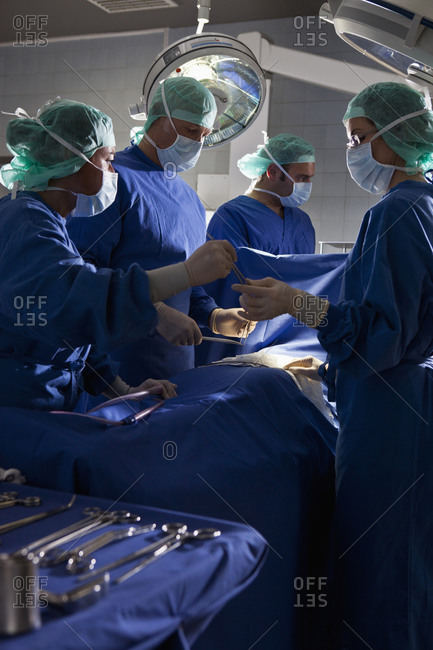 A surgery team operating on a patient in an operating room