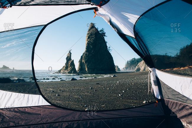 View of Rialto Beach and rock formations at dusk, camping tent in foreground, Olympic National Park, Washington, USA