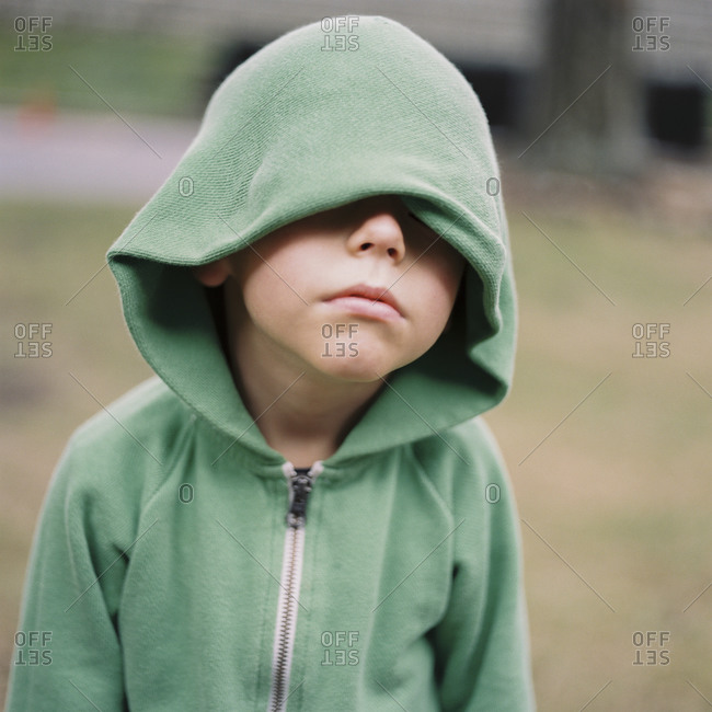 Portrait of boy with hood covering eyes