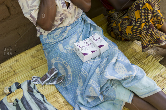 A HIV positive woman receives her dose of pills in Ndallam Village, Malawi