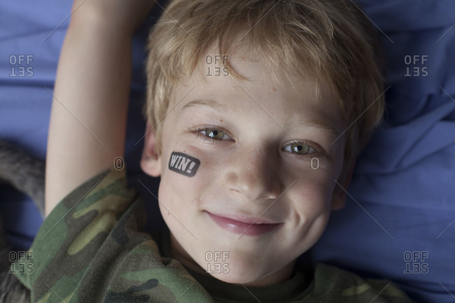 A boy with a temporary tattoo on his face