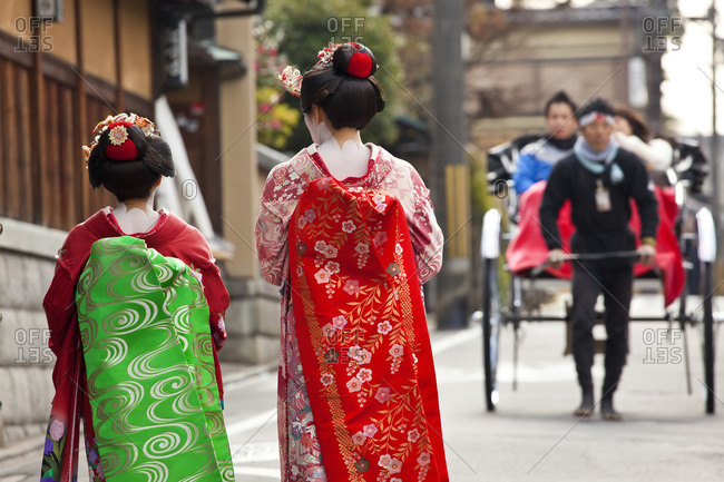 Geishas walking down the street in Kyoto, Japan