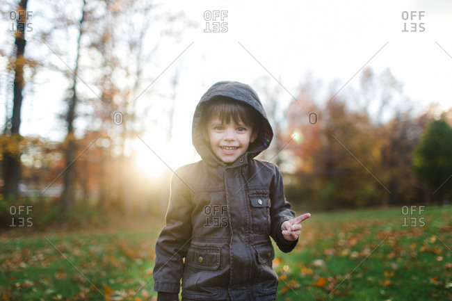 Boy in yard in fall jacket