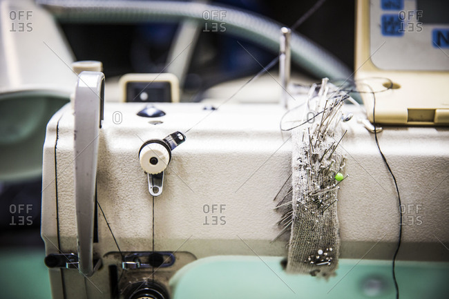 Close up of sewing machine with pins