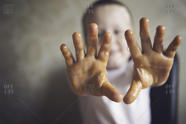 Boy showing messy hands from pumpkin