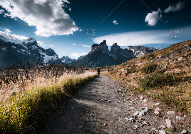A hiker walks down a trail in the Argentinean landscape