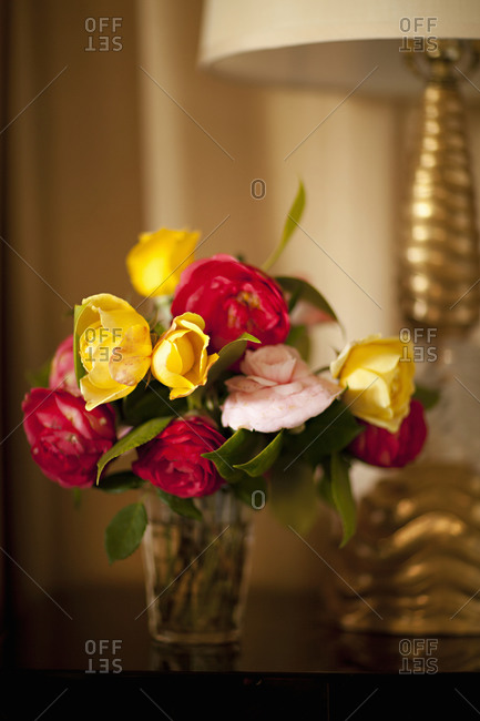 A bouquet of multicolor roses on a side table