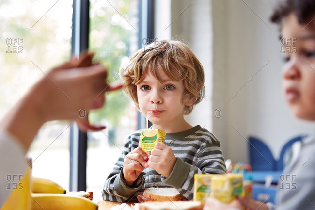 Boy at school with juice box