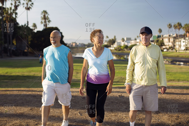 Three older people take a walk