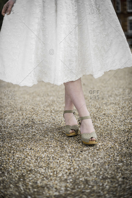 Bride posing in vintage wedding shoes