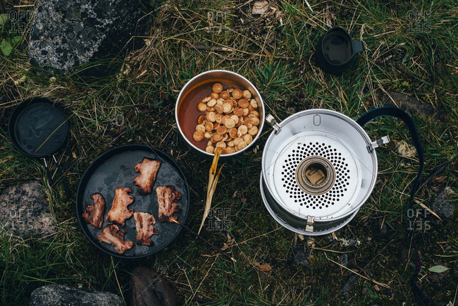 Crispy bacon and stew at a campsite