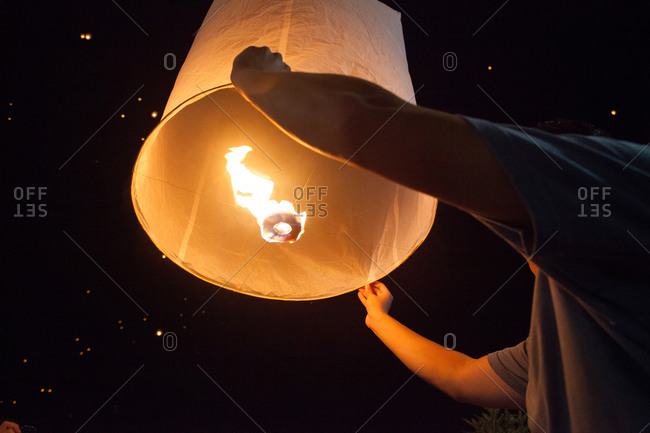 Man releasing a sky lantern