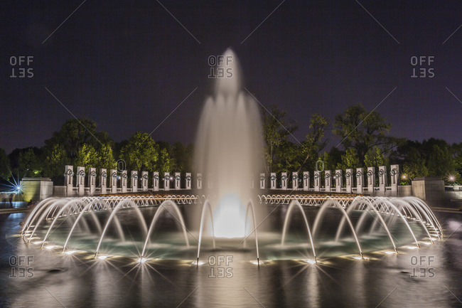 The fountains and sculpture of the World War II Memorial lit up at night, Washington D.C.