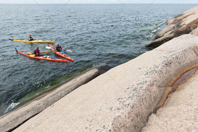 People kayaking on sea