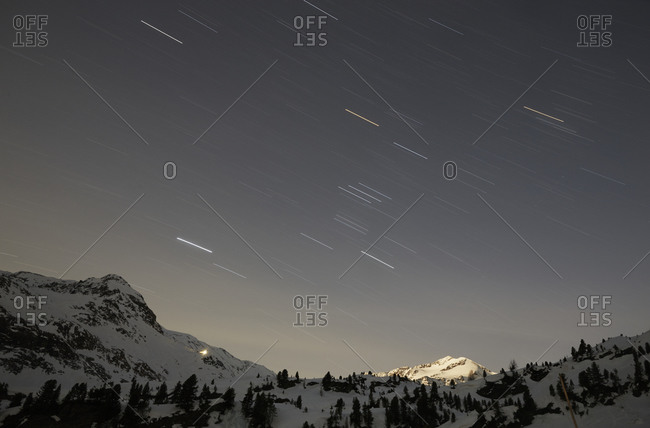 Starry sky over snow covered mountains