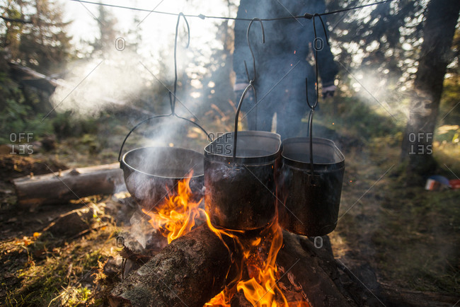 Close up of a dish cooking over a campfire