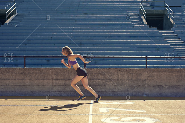 A woman sprints at a track