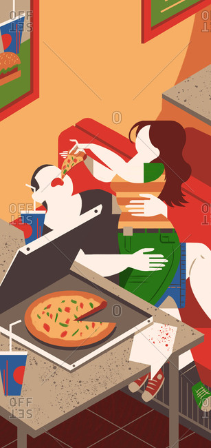 Woman feeding pizza to her boyfriend