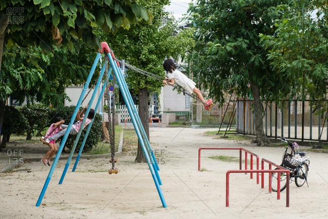 Children playing on a swing set, Osaka, Japan