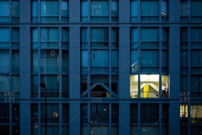 One illuminated window in a large building in the evening, Osaka, Japan