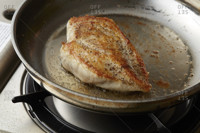 Chicken breast roasting in a pan
