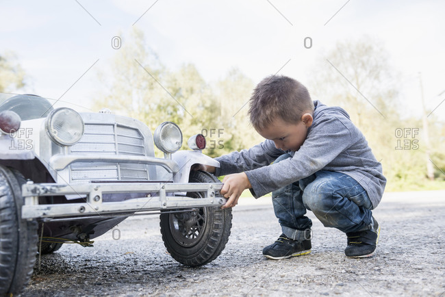 Boy child controlling wheel model toy vintage car