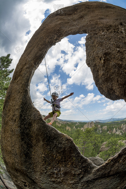 A young girl rock climbing near Mount Rushmore in the Black Hills, Hill City, South Dakota.