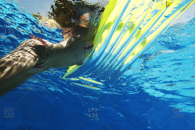 Underwater View Of Woman In Bikini Floating On Raft Stock Photo Offset